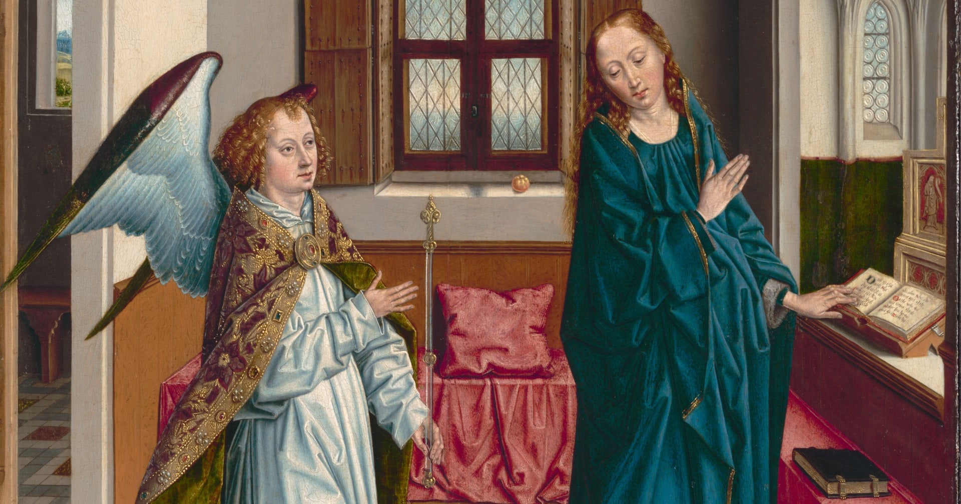 A painted panel: an angel in a jewelled cope raises a hand toward the Virgin, who stands with hands crossed in a tiled Gothic interior with a shuttered window, a curtained bed and a prayer desk.